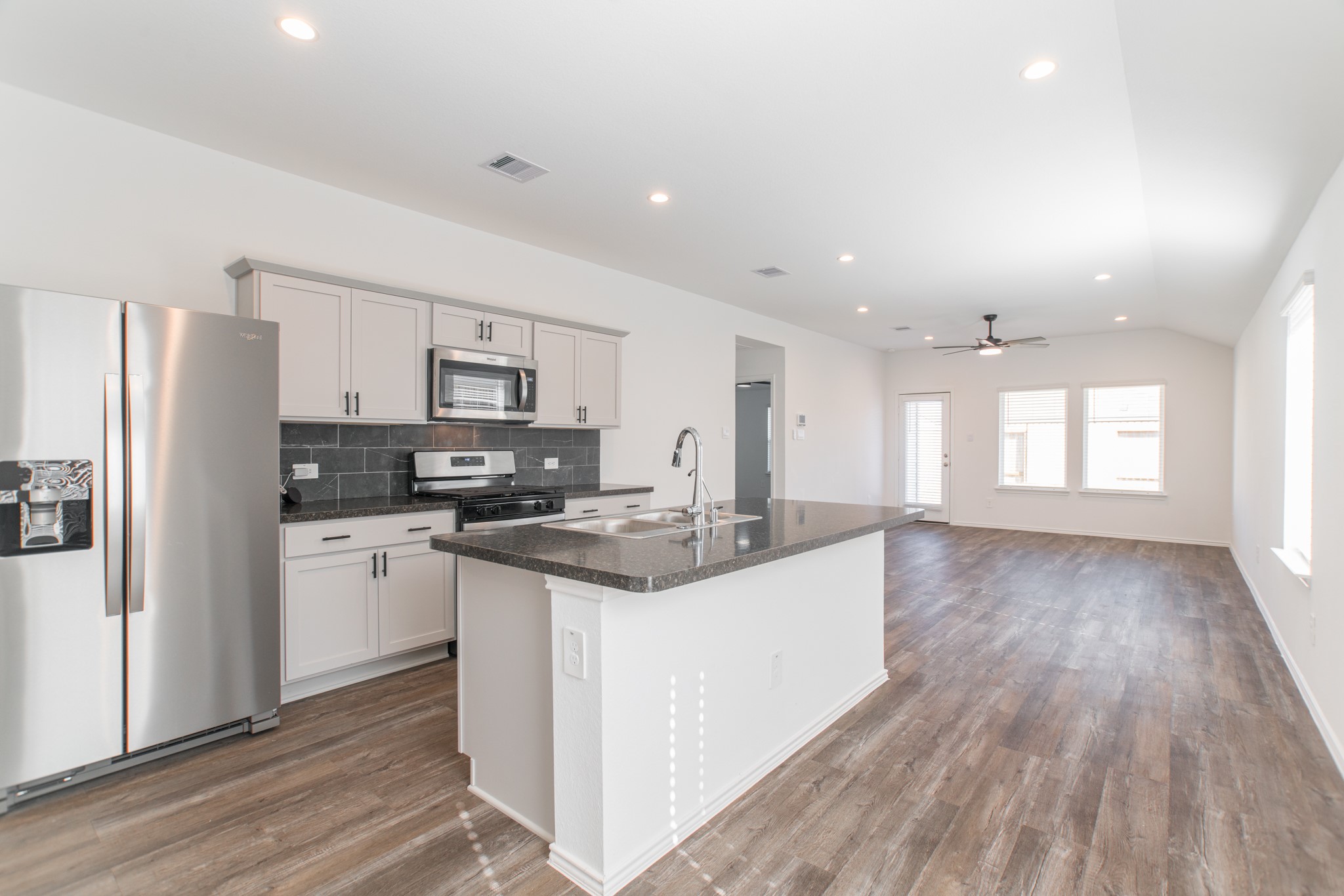 24314 Pebble Cres Lane Spring, TX 77373 - Photo 6 of 37 a kitchen with stainless steel appliances granite countertop a sink stove and refrigerator