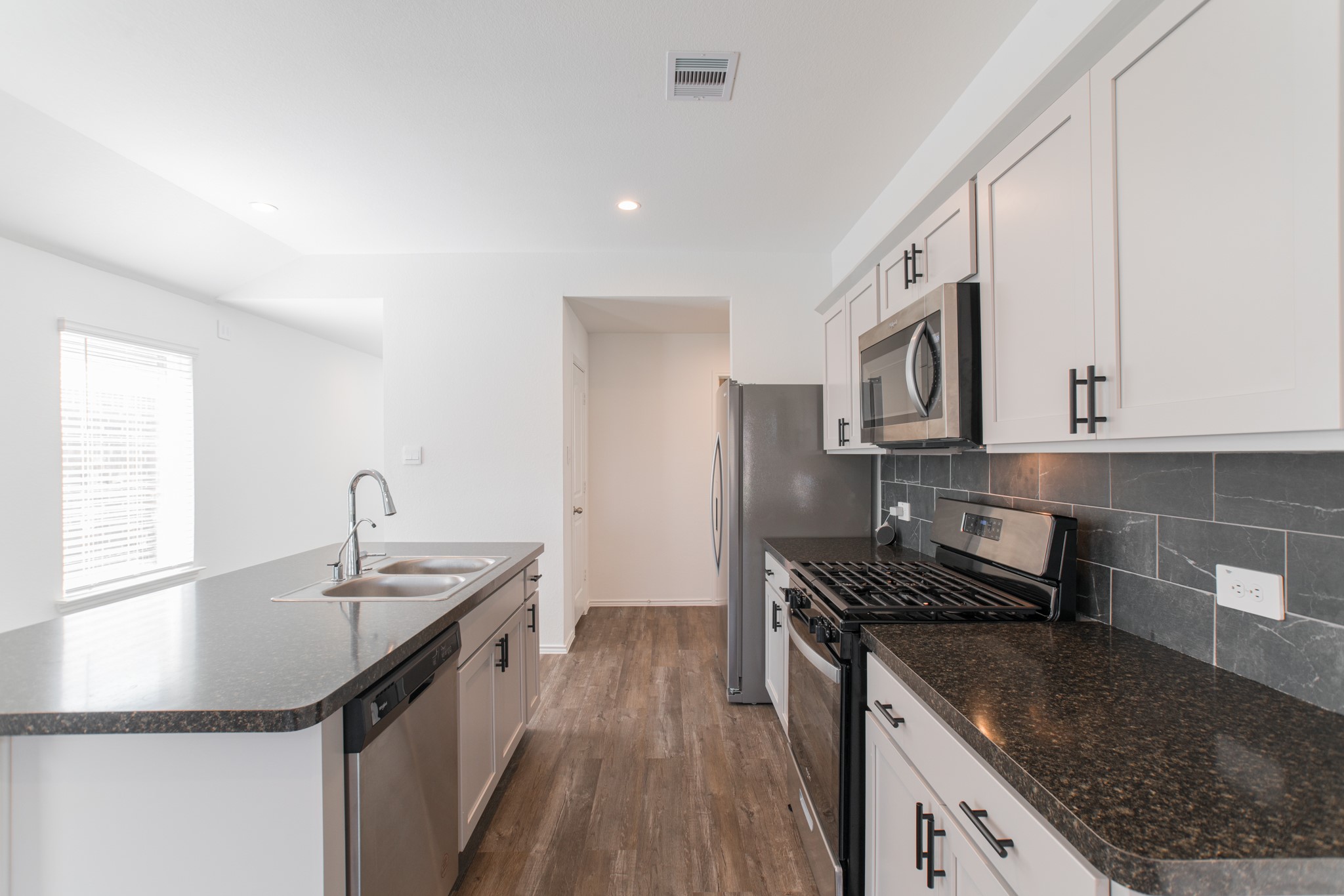 24314 Pebble Cres Lane Spring, TX 77373 - Photo 9 of 37 a kitchen with stainless steel appliances granite countertop a sink stove and refrigerator