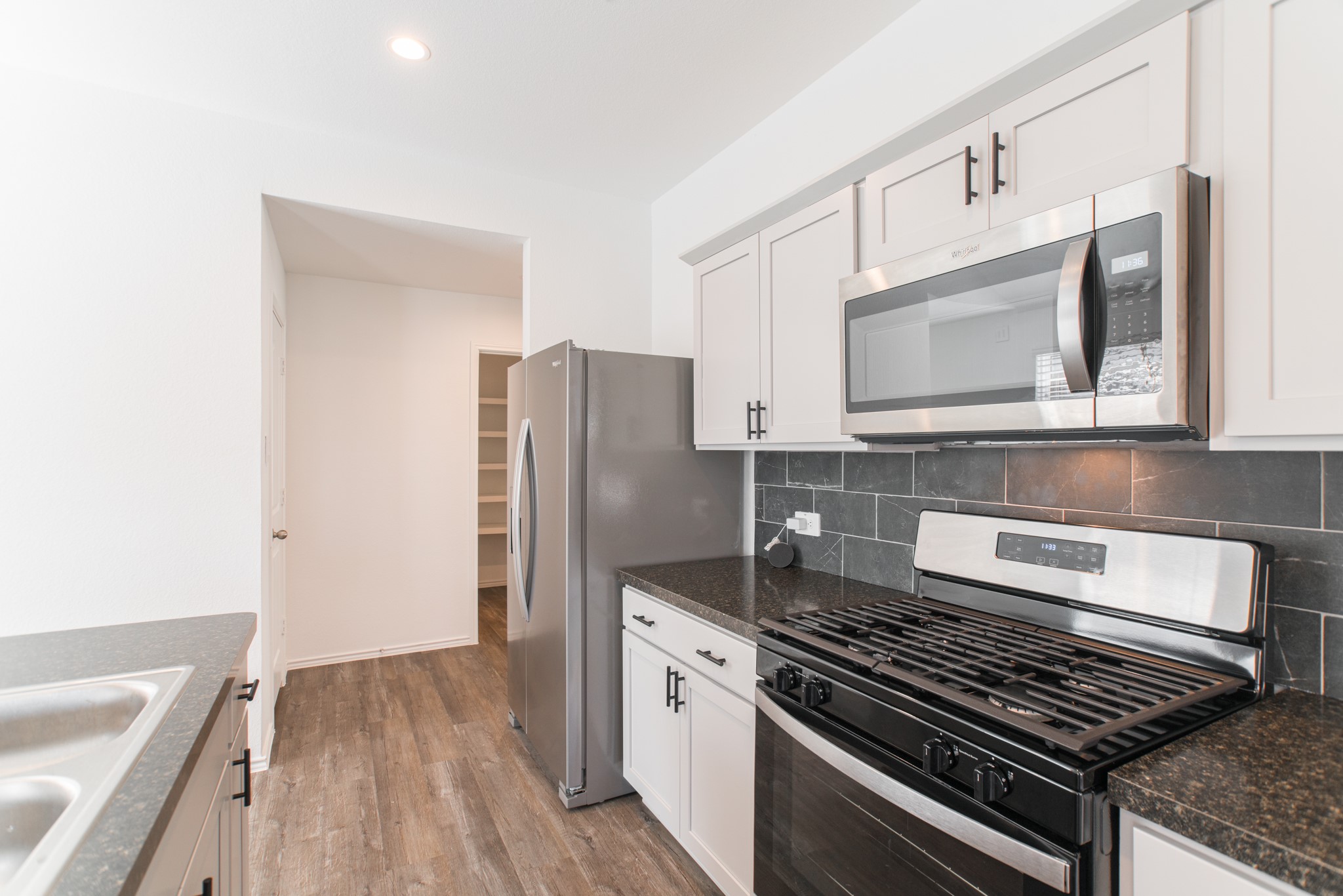 24314 Pebble Cres Lane Spring, TX 77373 - Photo 10 of 37 a kitchen with stainless steel appliances granite countertop a stove and a refrigerator