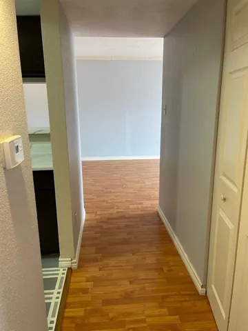 view of an empty room with wooden floor