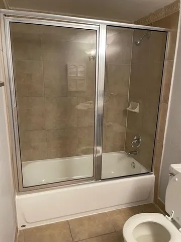 a bathroom with a shower and toilet