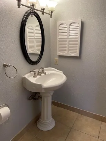 a bathroom with a sink a mirror and a window