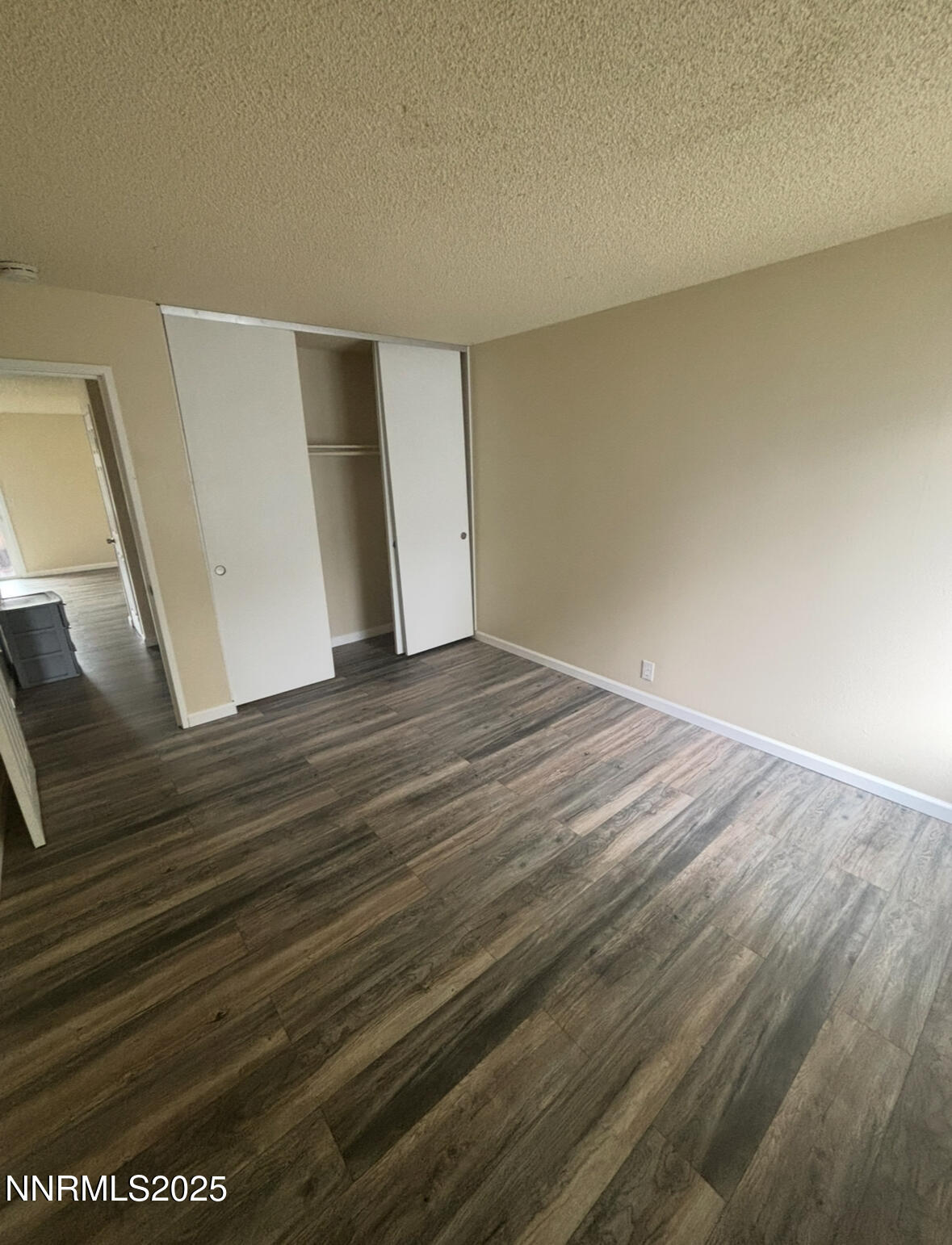4604 Neil Road, Unit 114 Reno, NV 89502 - Photo 11 of 15 a view of an empty room with wooden floor
