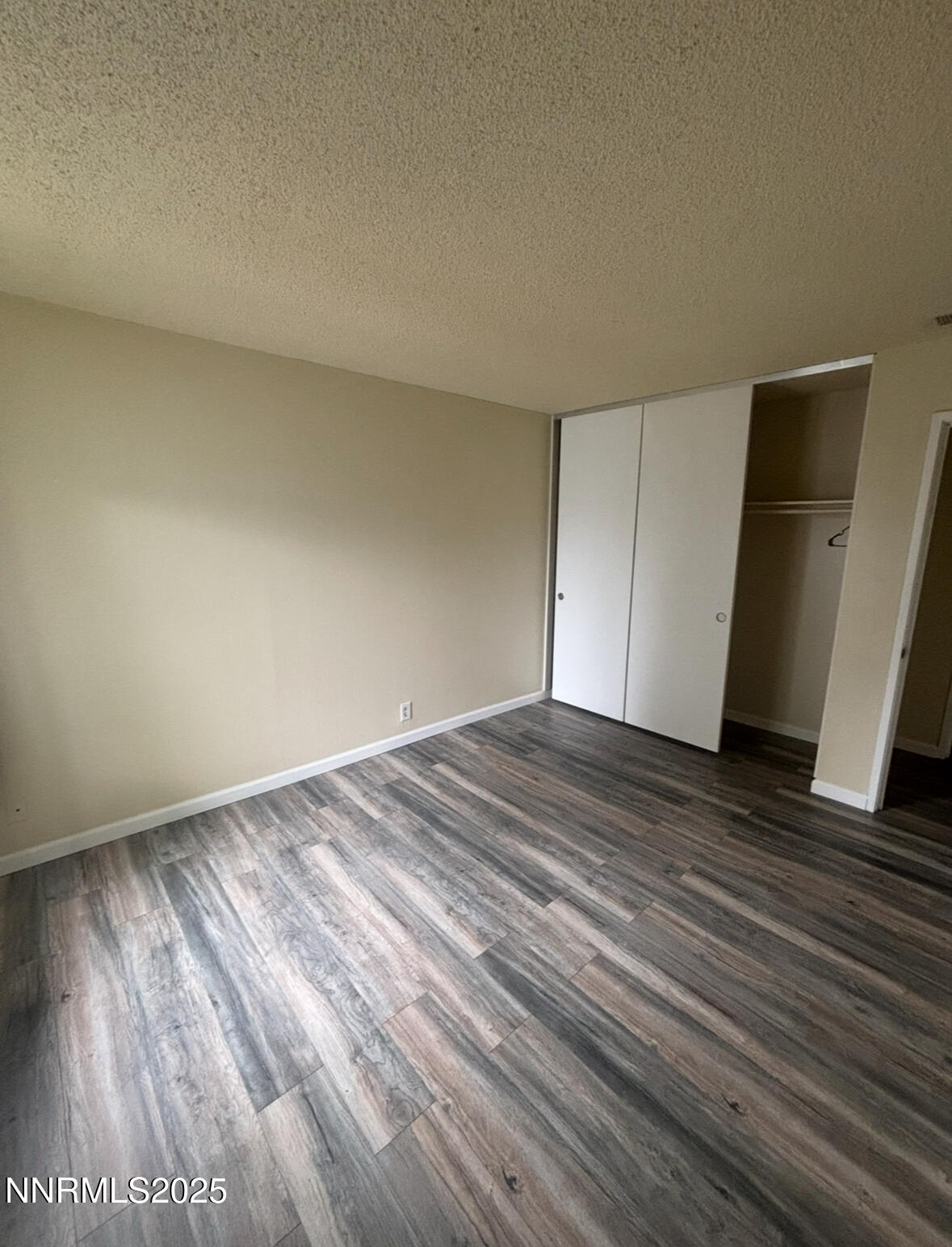 4604 Neil Road, Unit 114 Reno, NV 89502 - Photo 13 of 15 a view of empty room with wooden floor