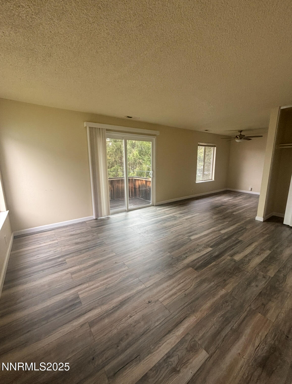 4604 Neil Road, Unit 114 Reno, NV 89502 - Photo 2 of 15 a view of an empty room with a window and wooden floor