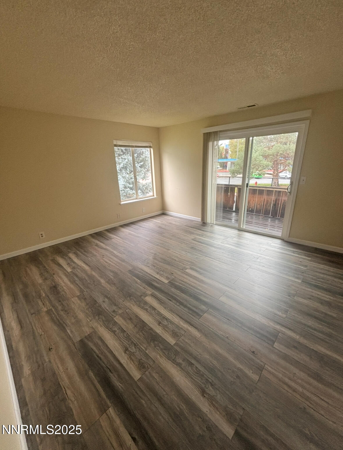4604 Neil Road, Unit 114 Reno, NV 89502 - Photo 3 of 15 wooden floor in an empty room with a window