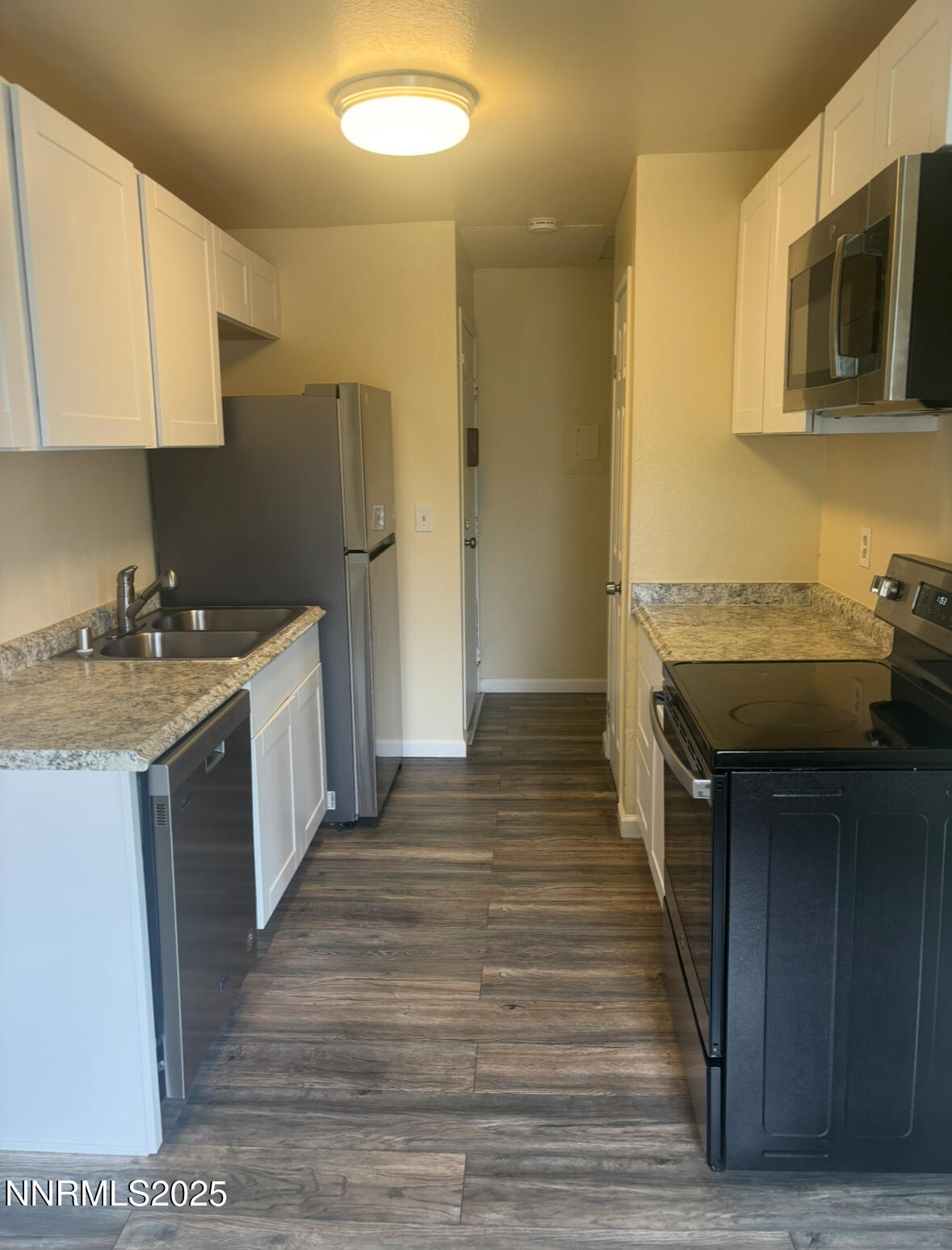4604 Neil Road, Unit 114 Reno, NV 89502 - Photo 7 of 15 a kitchen with a sink a microwave and cabinets