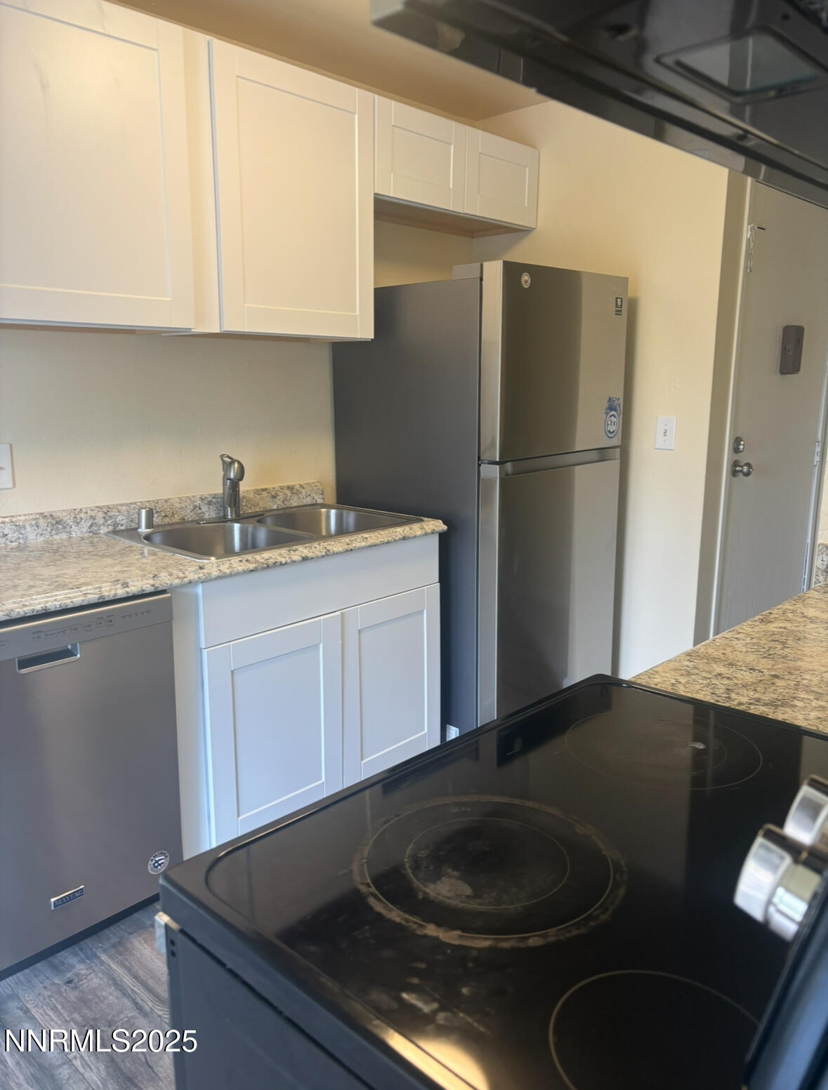 4604 Neil Road, Unit 114 Reno, NV 89502 - Photo 8 of 15 a kitchen with a sink and a refrigerator
