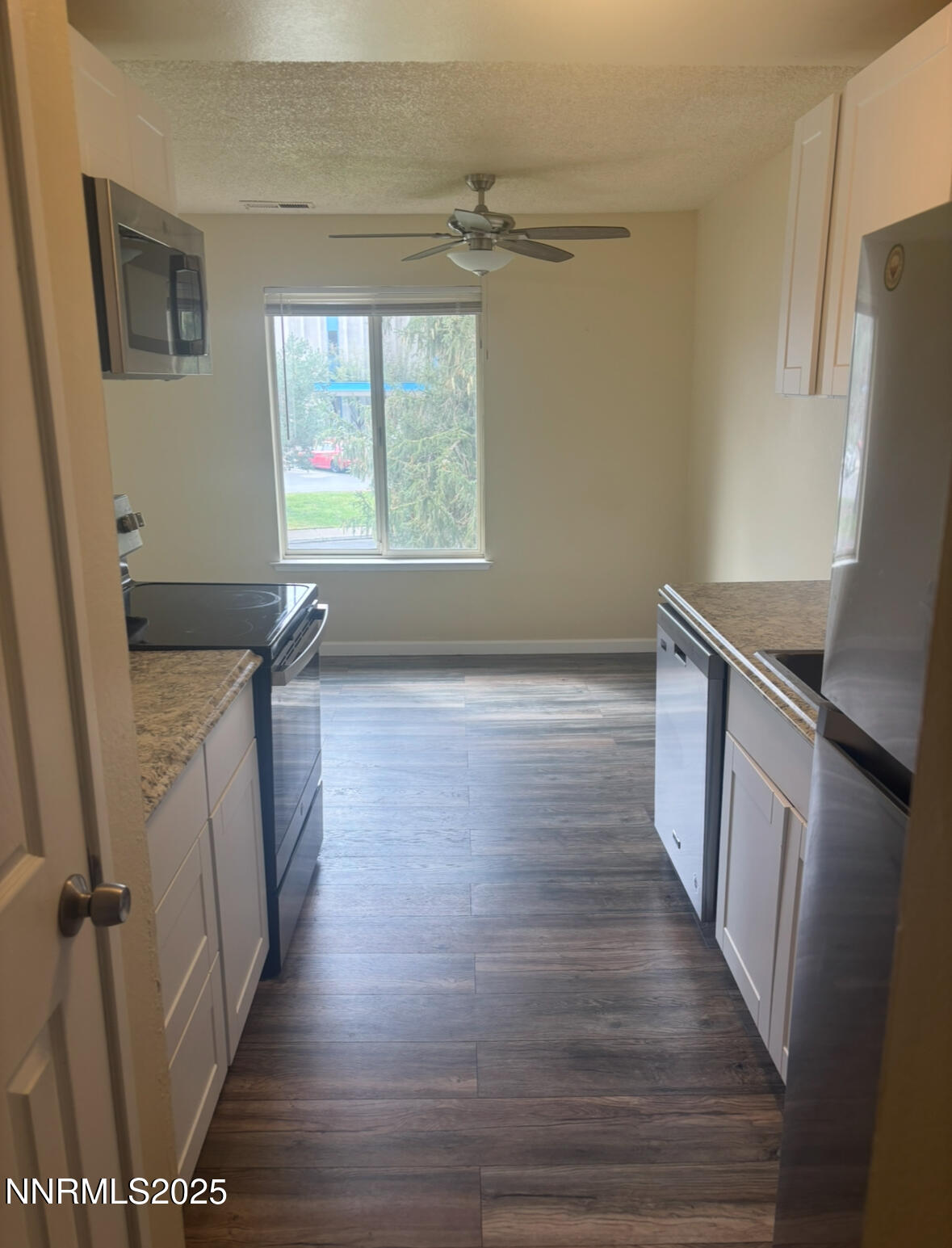 4604 Neil Road, Unit 114 Reno, NV 89502 - Photo 10 of 15 a view of a hallway with wooden floor and staircase