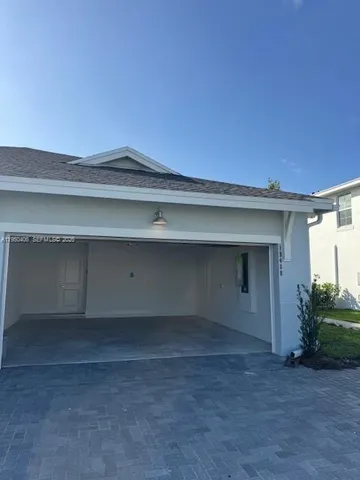 a room with a wooden floor and potted plants
