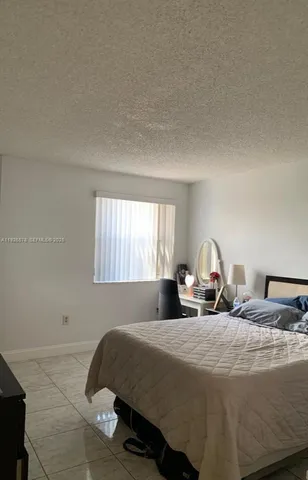 a bedroom with two beds and a window