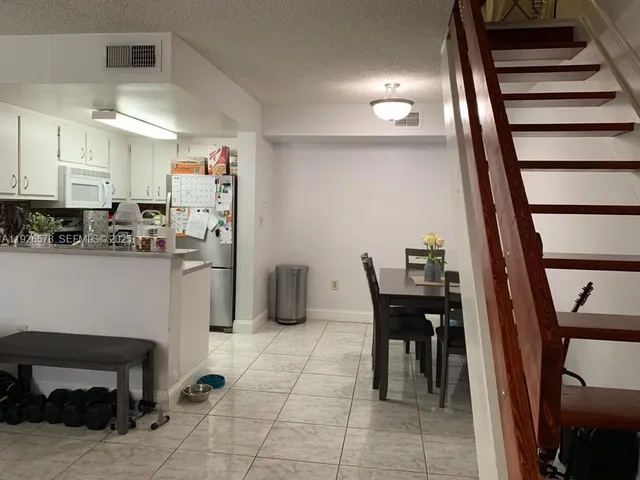 a view of kitchen with furniture and wooden floor