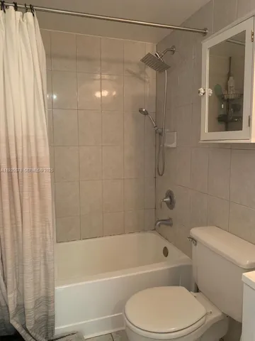a bathroom with a toilet and a bath tub
