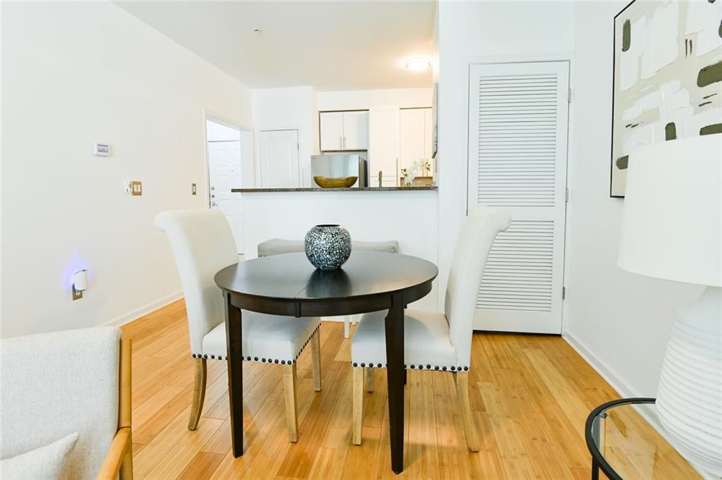 821 Ralph McGill Boulevard Northeast, Unit 2416 Atlanta, GA 30306 - Photo 11 of 44 a view of a dining room with furniture and wooden floor