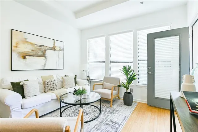 a living room with furniture and a wooden floor