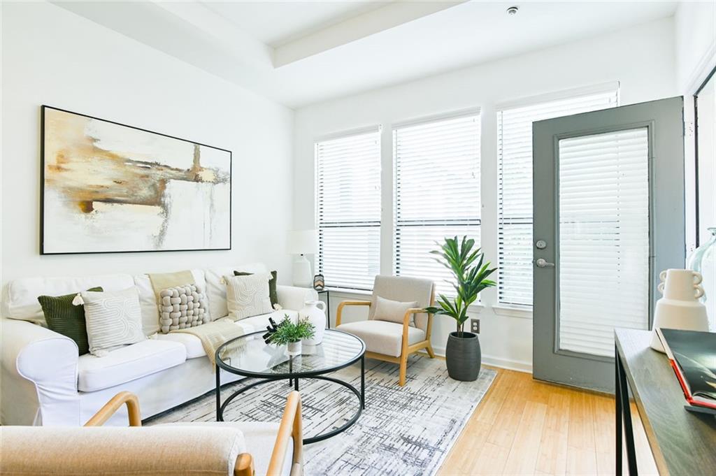 821 Ralph McGill Boulevard Northeast, Unit 2416 Atlanta, GA 30306 - Photo 12 of 44 a living room with furniture and a large window
