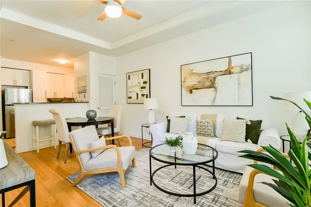 a living room with furniture and a wooden floor