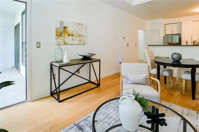 a living room with furniture a window and wooden floor