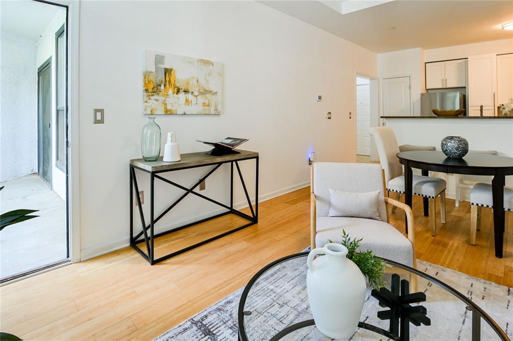 821 Ralph McGill Boulevard Northeast, Unit 2416 Atlanta, GA 30306 - Photo 14 of 44 a living room with furniture and a wooden floor