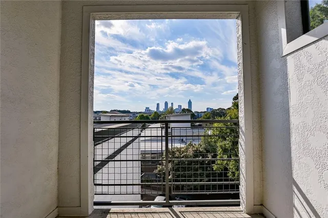 a front view of a house with wooden floor and a potted plant