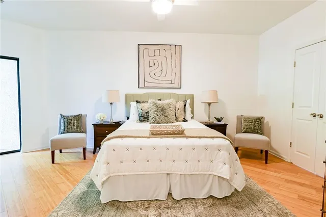 a bedroom with a bed and a lamp