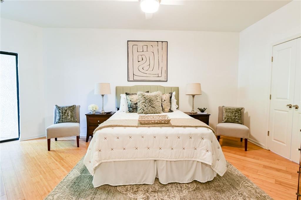 821 Ralph McGill Boulevard Northeast, Unit 2416 Atlanta, GA 30306 - Photo 22 of 44 a spacious bedroom with a bed and painting on the wall