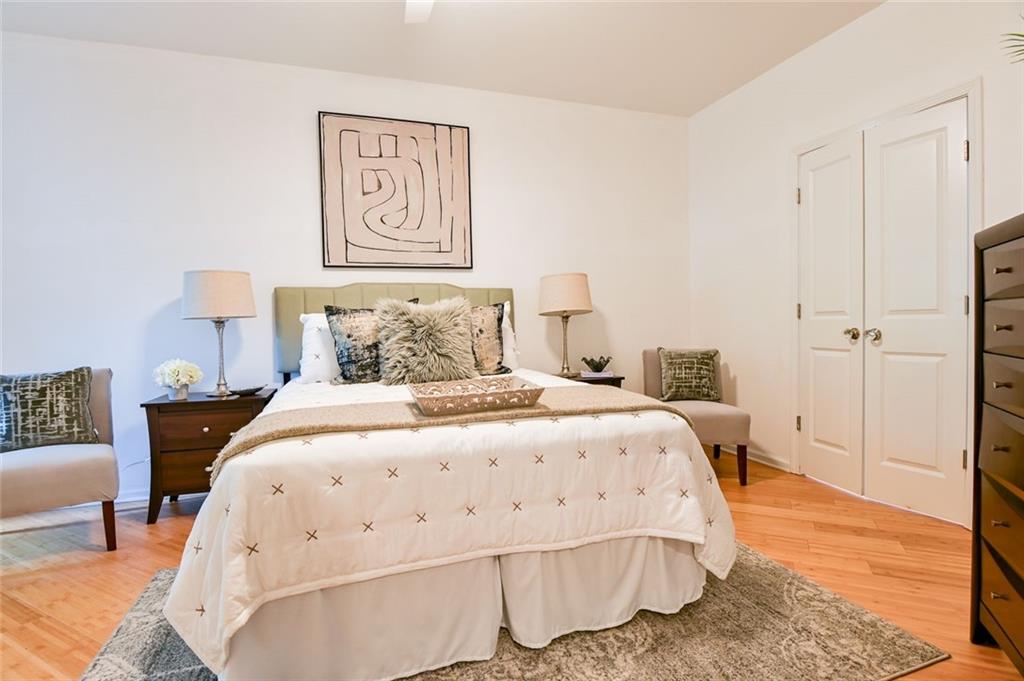 821 Ralph McGill Boulevard Northeast, Unit 2416 Atlanta, GA 30306 - Photo 23 of 44 a spacious bedroom with a bed and a lamp