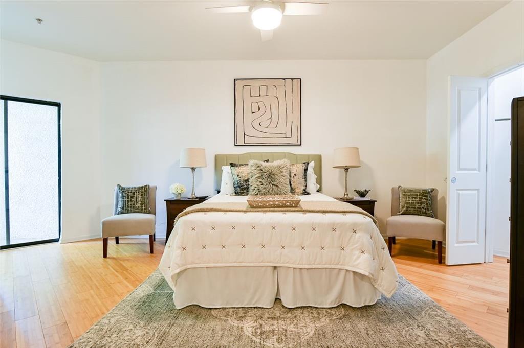 821 Ralph McGill Boulevard Northeast, Unit 2416 Atlanta, GA 30306 - Photo 24 of 44 a bedroom with a bed and a lamp