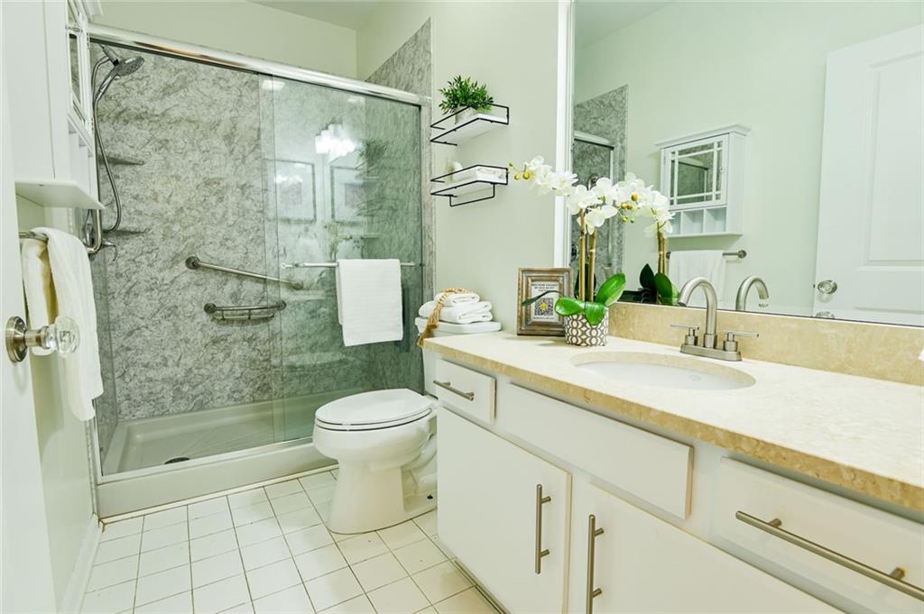 821 Ralph McGill Boulevard Northeast, Unit 2416 Atlanta, GA 30306 - Photo 26 of 44 a bathroom with a sink a toilet and shower