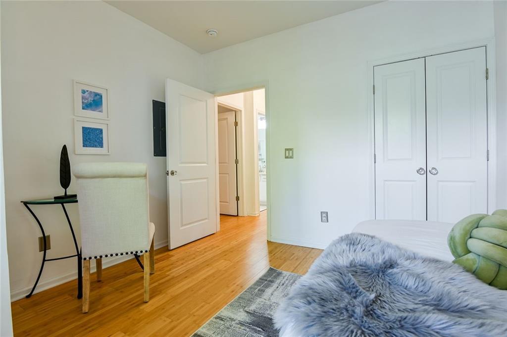 821 Ralph McGill Boulevard Northeast, Unit 2416 Atlanta, GA 30306 - Photo 29 of 44 a bedroom with a bed and wooden floor