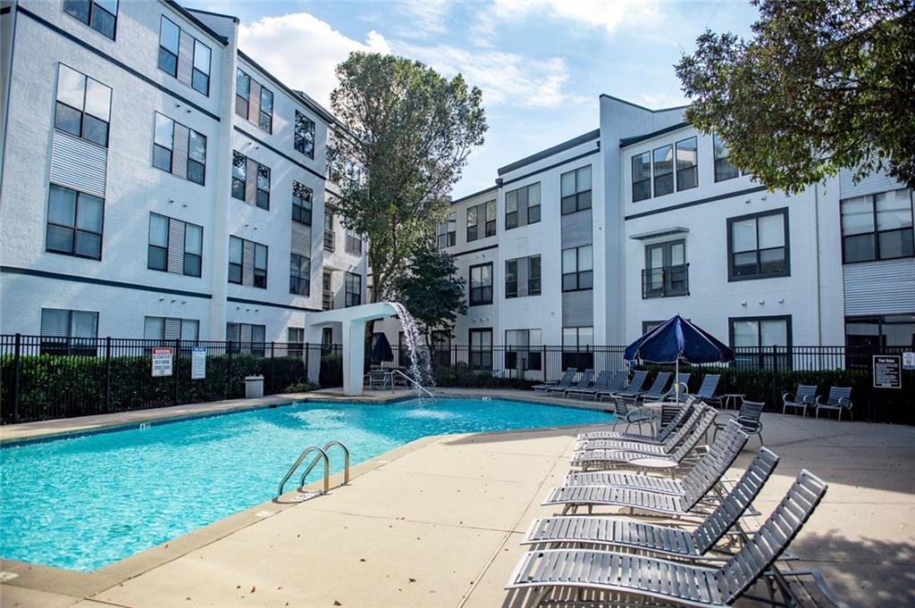 821 Ralph McGill Boulevard Northeast, Unit 2416 Atlanta, GA 30306 - Photo 36 of 44 a front view of a building with garden and trees