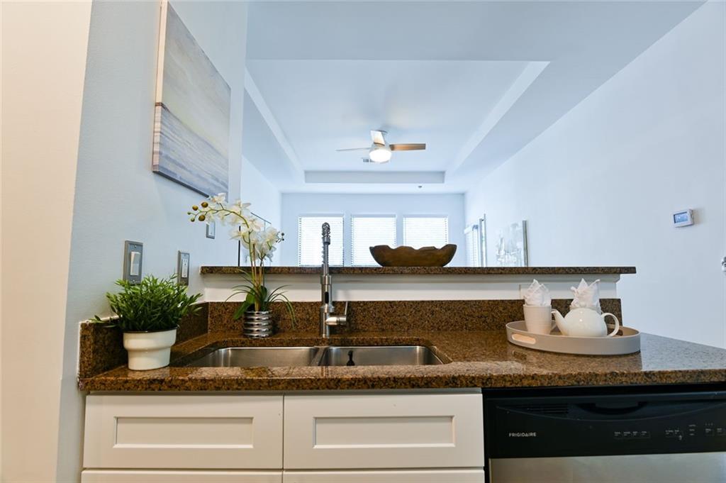 821 Ralph McGill Boulevard Northeast, Unit 2416 Atlanta, GA 30306 - Photo 9 of 44 a kitchen with granite countertop a sink a stove and cabinets
