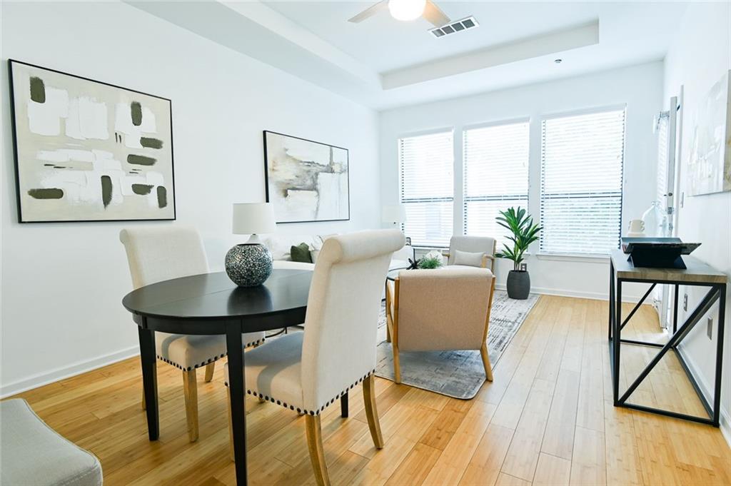821 Ralph McGill Boulevard Northeast, Unit 2416 Atlanta, GA 30306 - Photo 10 of 44 a view of a dining room with furniture and a large window