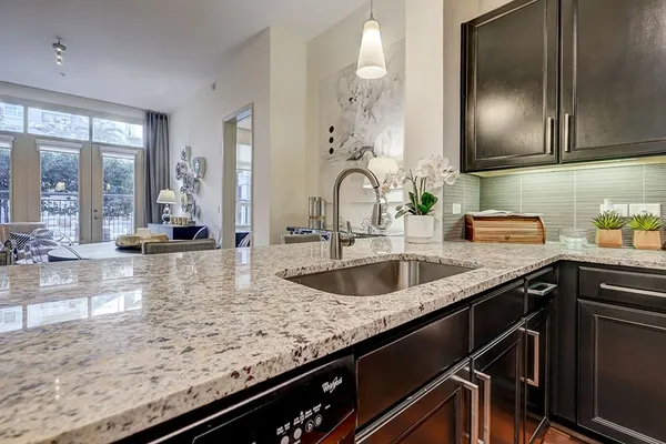 a kitchen with granite countertop a sink and cabinets