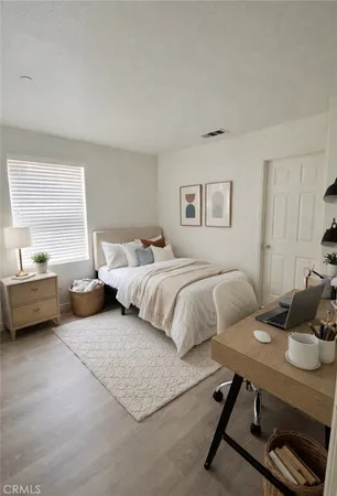 a bedroom with a bed and a couch