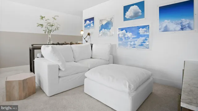 a living room with furniture and flowers