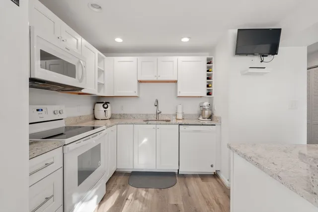 a kitchen with a sink stove and microwave