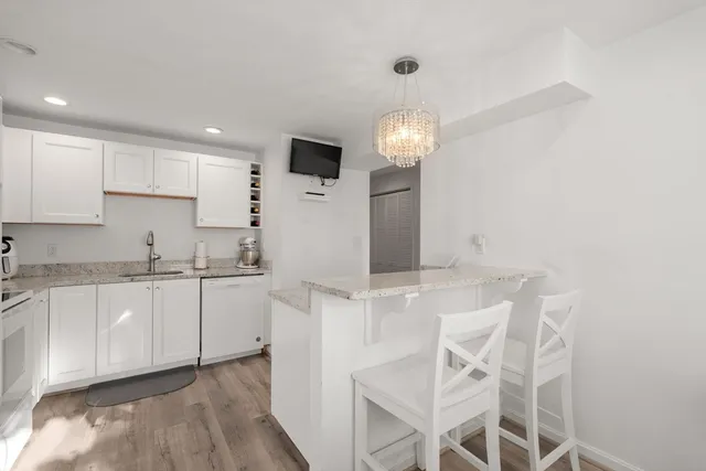 a kitchen with stainless steel appliances kitchen island granite countertop a sink and cabinets