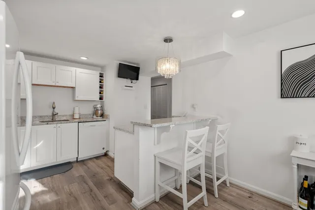 a kitchen with cabinets and chairs