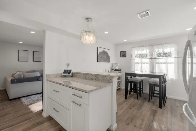 a kitchen with center island table and chairs