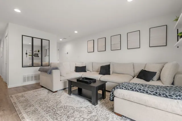 a living room with furniture and a rug