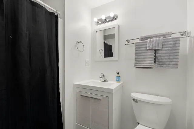 a bathroom with a sink a toilet and mirror