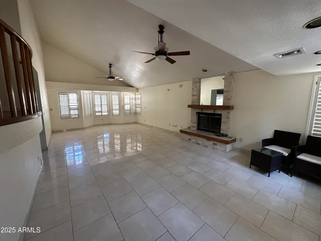 a kitchen with stainless steel appliances a refrigerator a stove a sink a dining table and chairs