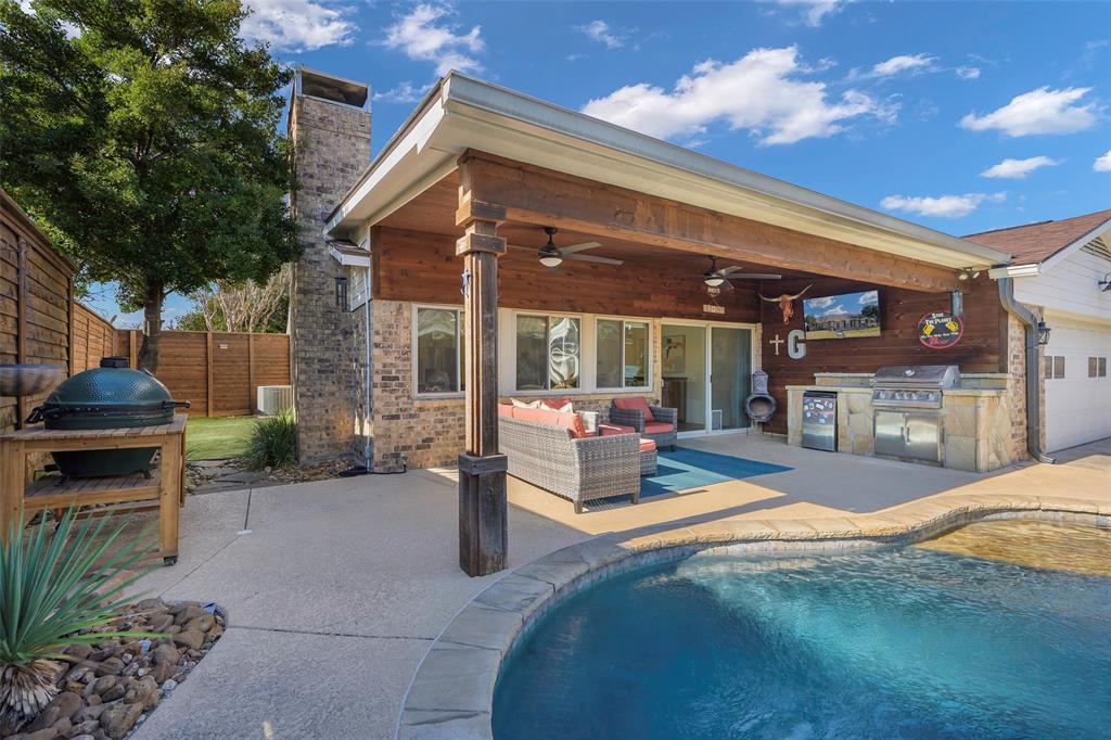 a view of a house with backyard porch and sitting area