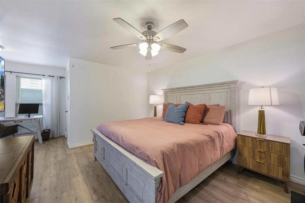 5810 Galaxie Road Garland, TX 75044 - Photo 12 of 33 a bedroom with a bed and wooden floor