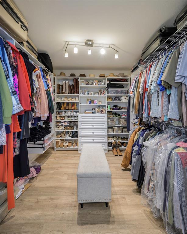 5810 Galaxie Road Garland, TX 75044 - Photo 17 of 33 a view of walk in closet with clothes and shoes