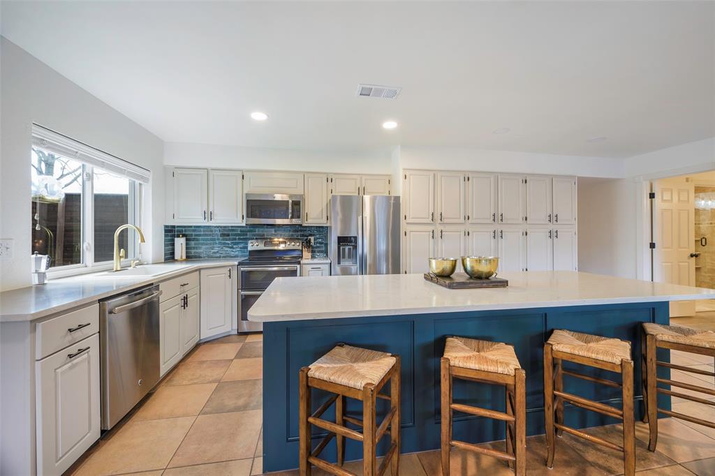 5810 Galaxie Road Garland, TX 75044 - Photo 2 of 33 a large kitchen with cabinets table and chairs