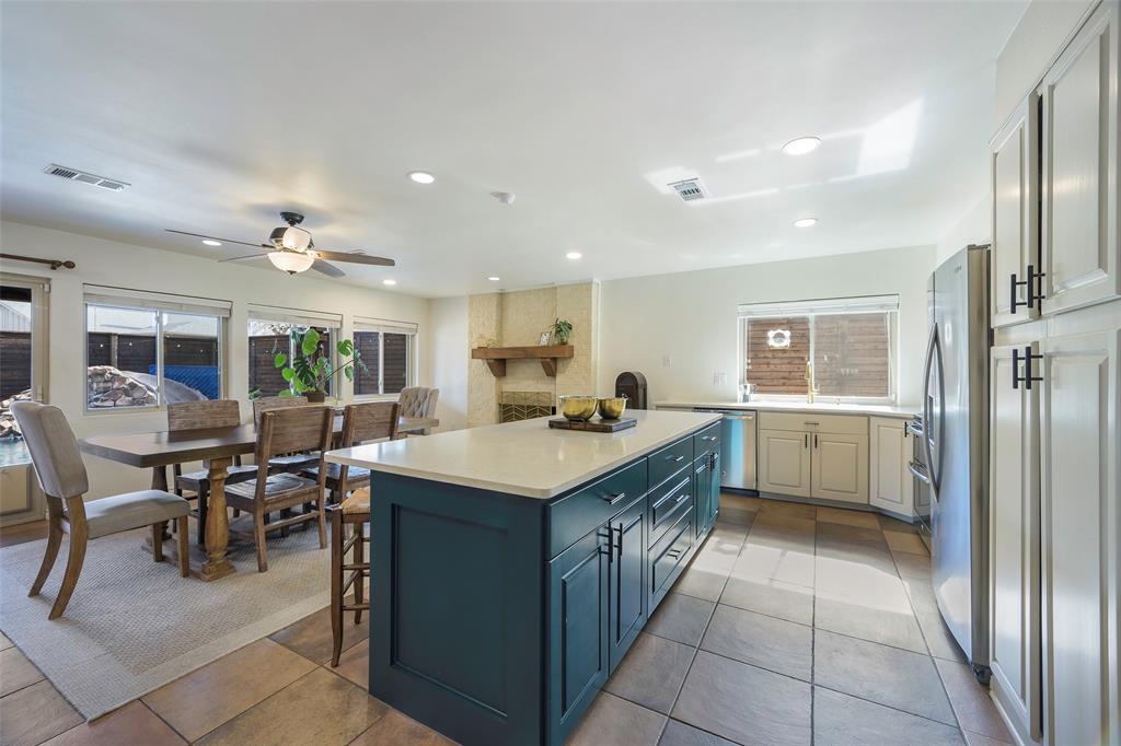5810 Galaxie Road Garland, TX 75044 - Photo 5 of 33 a kitchen with a stove a refrigerator and a dining table