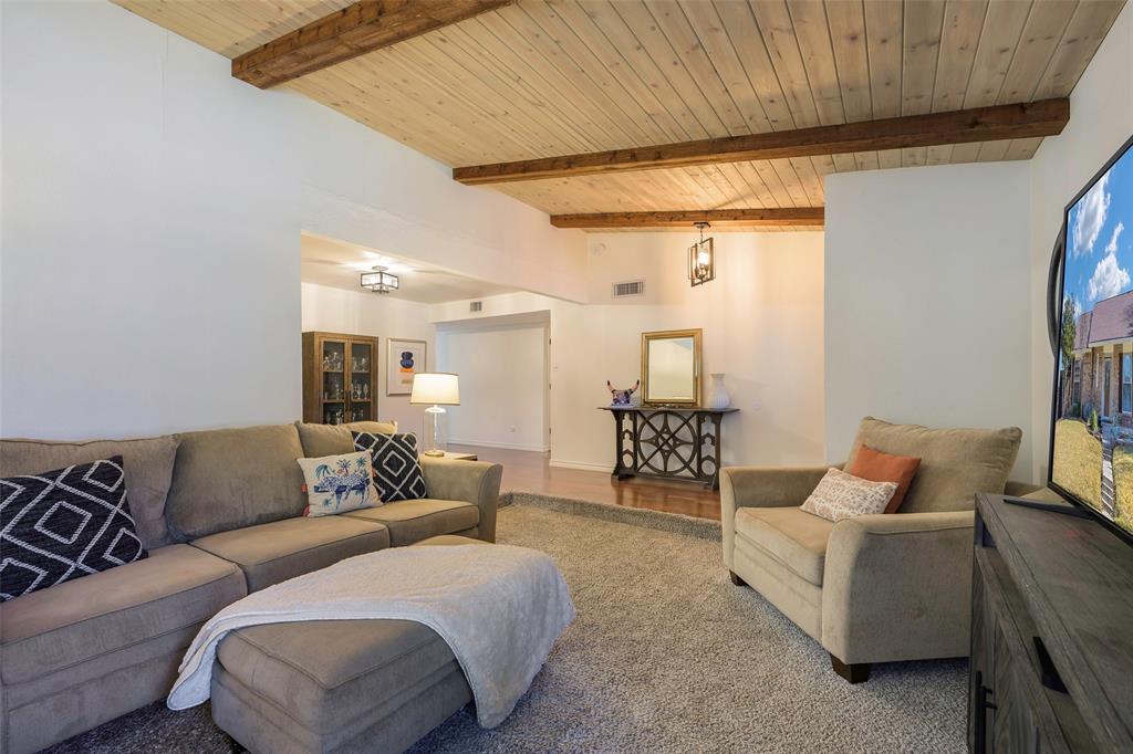 5810 Galaxie Road Garland, TX 75044 - Photo 10 of 33 a spacious bedroom with a bed and a couch