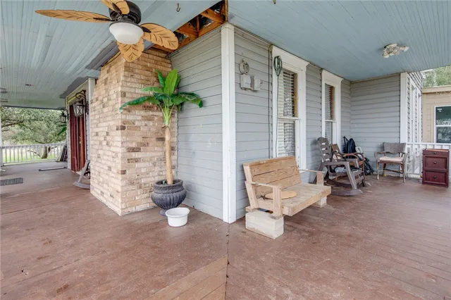 a view of a patio with chairs and potted plants